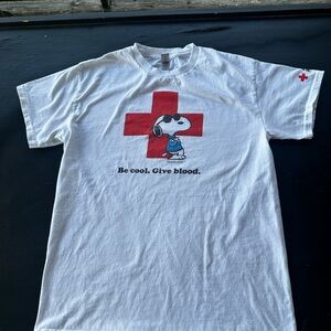 White T-Shirt with Red Cross and Snoopy Graphic